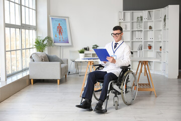 Young male doctor in wheelchair with clipboard at hospital