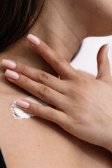 girl smears cream on her skin