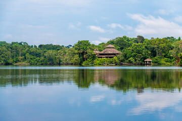 Amazon rainforest lodge reflection. Amazon river comprise the countries Suriname, (French) Guyana, Venezuela, Colombia, Peru, Brazil, Ecuador, Bolivia.