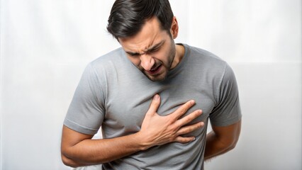 A man is holding his chest with both hands, suggesting discomfort or pain