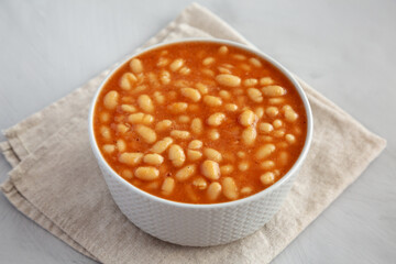Bowl of Canned White Beans with Tomato Sauce, side view.
