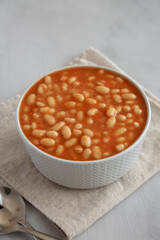 Bowl of Canned White Beans with Tomato Sauce, side view.