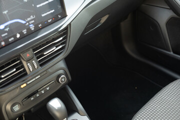 A close up view of the interior of a car showing the dashboard and passenger seat