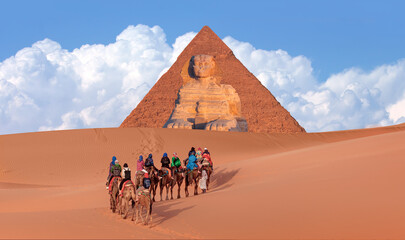 Group of tourists riding camels seeing the pyramids of Menkaure, Chephren and Cheops - Giza Pyramid...