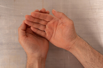 Two hands cupped together open and awaiting