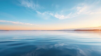 Fototapeta premium Tranquil blue water lake with a serene sunset sky.