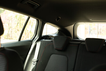 A black car interior with red stitching on the seats