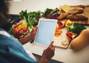Hands, kitchen counter and screen of tablet with vegetables recipe for cooking with diet, nutrition and fresh food. Person, home and mock up with research for organic ingredients and vegetarian meal