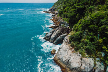 Coastline with rocks and blue ocean in Brazil on Matadeiro Beach. Aerial view