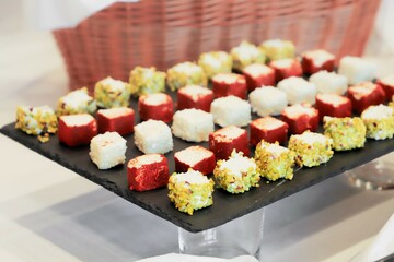 sushi rolls with wasabi. catering buffet with variety of food snacks and appetizers.