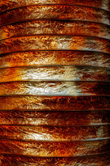 Flexible air duct for ventilation from confined spaces in the construction of large chemical storage tanks.