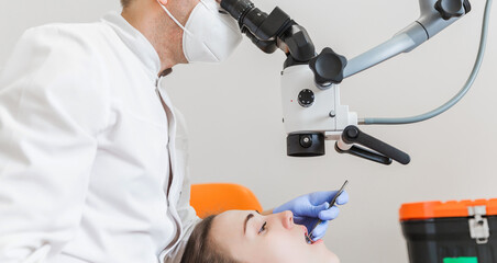 Dentist Using Dental Microscope for Patient Examination