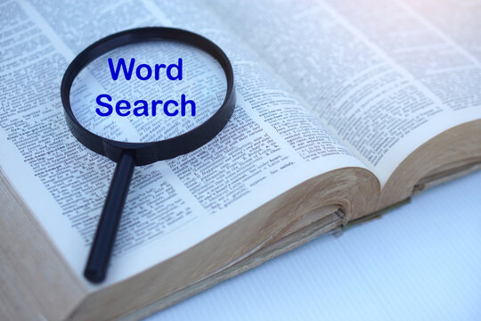 Magnifying glass highlighting the words "Word Search" on an open dictionary. Educational concept for vocabulary learning, language study, classroom activities, word puzzles, literacy, English educatio