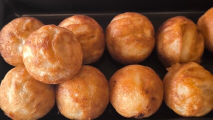 Takoyaki snacks on a black tray, Japanese style food