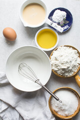 Overhead view of mise en place of ingredients for making a vanilla cake, flatlay of ingredients for making vanilla pound cake, process of making cake