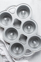 overhead view of swirl bundtlette pan, flatlay of six cavity mini bundt pan, top view of cast iron baking pan
