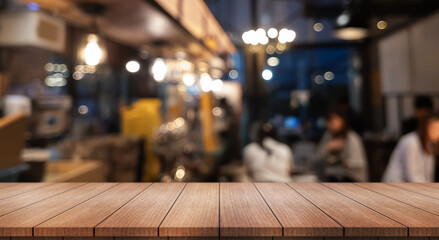 Empty wooden table top with lights bokeh on blur restaurant background.