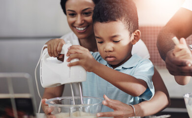 Mother, child and baking with whisk machine for bonding, family time or help in kitchen at home. Mom, son or little boy preparing cookies, dough or mixture together with ingredients in bowl for snack