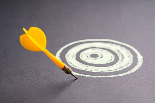 Inaccurate dart sticks outside the target, business, and communication concept