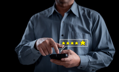 A business professional confidently uses a mobile device to give a 5-star rating, expressing satisfaction and appreciation for the exceptional services recently the value of quality service business.