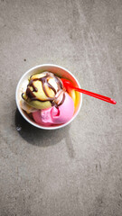 Popsicles in paper cups and red spoons