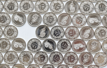 coins linearly spread on white background with a gap
