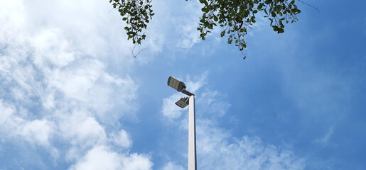 A modern street LED lighting pole. LED Street Light on blue sky, cloud background. electro-energy...