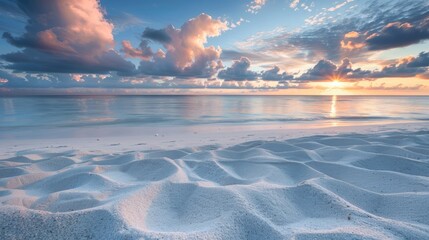 A quiet beach with fine, white sand, the sunrise creating a soft, pink glow across the horizon.