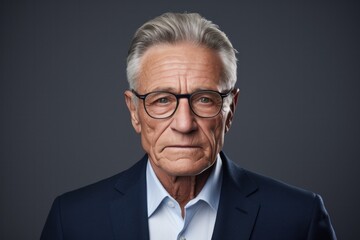 Elegant man with delicate eyes against a gray background.