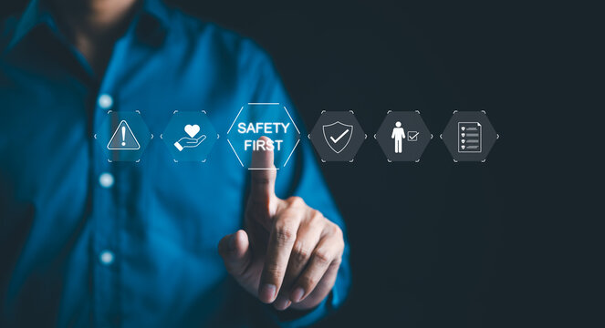 Safety First concept. Work safety, A businessman with safety icons, emphasizing the "Safety First" concept, with icons for warning, health, verification, and compliance. regulations and insurance,