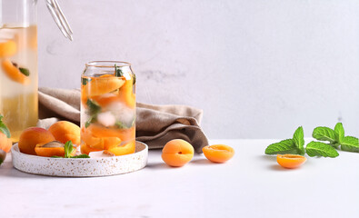 summer drink apricot lemonade with ice and mint