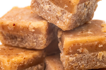 Creamy, crumbly and decadent fudge tasty, sweet, dessert, treat, confectionery, indulgent. On a white isolated background with copy space.