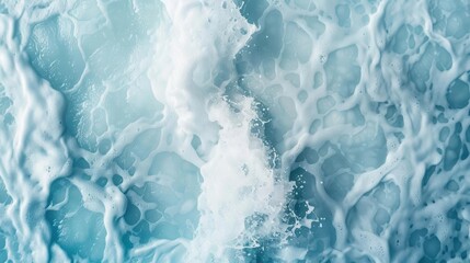 Obraz premium Abstract Aerial View of Turbulent Foamy Ocean Waves in Soft Blue Tones