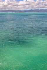 Fototapeta premium Exposure of the beautiful water color in Wellington Harbour, after crossing the Cook Strait and before arriving by boat to Wellington and pass the Pencarrow Head, New Zealand.