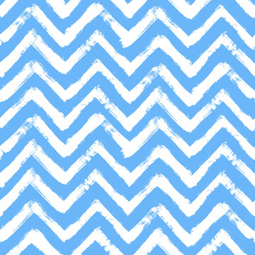 Vector chevron pattern. Seamless blue and white brush stroke background. Zig zag print with distress texture. Painted ornament for kids. Childish design