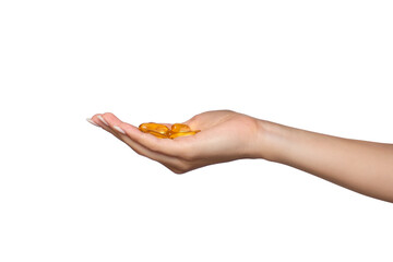 A woman holds a handful of vitamins or yellow capsules in her hand. Isolated on a white background. The girl has omega in her palm for beautiful skin, hair and nails. Beauty and health concept
