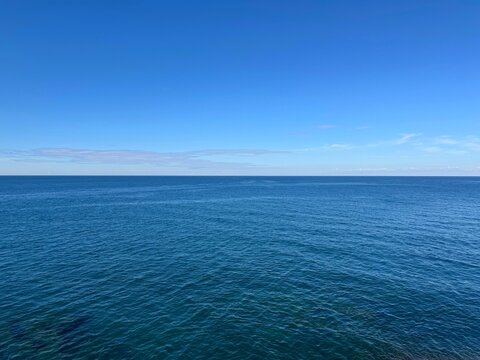 Dark blue sea and clear sky on horizon 