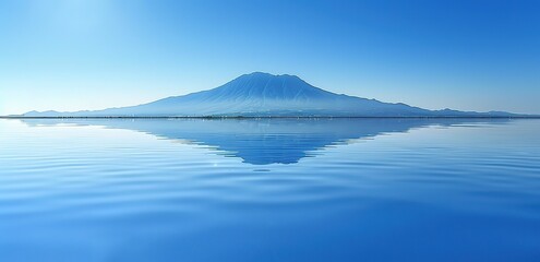 A blue sea that reflects mountains with a blue and white background