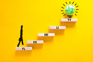 Flexibility symbol. Concept word Flexibility on beautiful wooden blocks. Businesswoman icon....