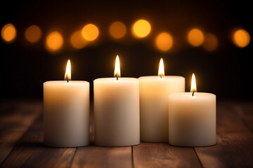 candles white with flickering flames dark blurred background