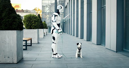 Artificial intelligence machine going walk dog in the morning. Robot standing near building keeps pet on green leash. Walking dogs is cool activity for everyone.
