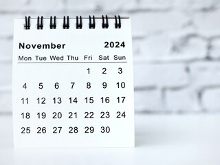 November 2024 white monthly desk calendar on a table