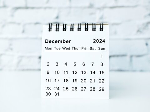 December 2024 white monthly desk calendar on a table