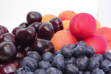 fresh fruits and berries cherry apricot and blueberry