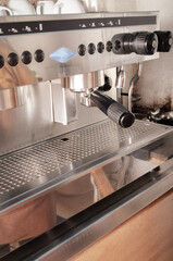 Pressed coffee ready to be served in an automatic freshly ground coffee machine. Coffee machine. Closed angle.