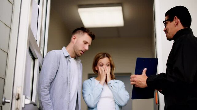 Bailiff speaking to a distressed couple