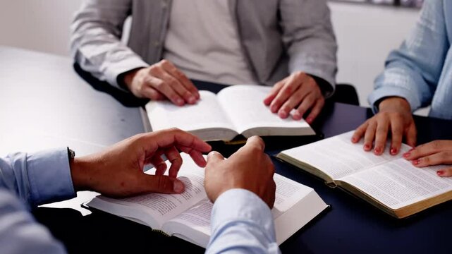 Man in Christian ministry office, bible open, studying scriptures