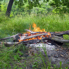 View of the burning campfire in camp