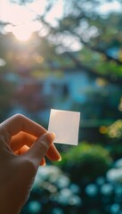 Hand Holding Mosquito Repellent Patch in Summer Garden for Natural Insect Protection