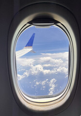 Airplane wing on a blue sky. Plane travel